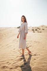 Modest women's linen midi dress that has midi sleeves, v-neckline and belt around waist.