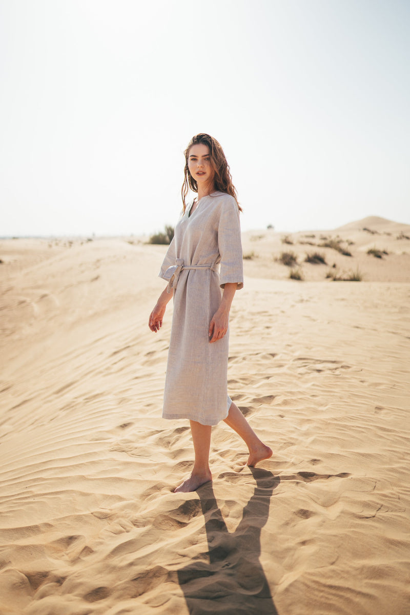 Modest women's linen midi dress that has midi sleeves, v-neckline and belt around waist.